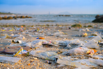 Trash, plastic cups and plastic bags at the beach. environmental problem concept and healing the world	