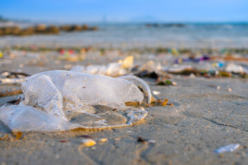 Trash, plastic cups and plastic bags at the beach. environmental problem concept and healing the world	