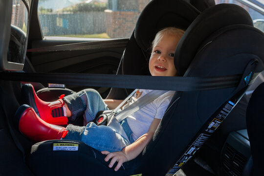 Little girl buckled into extended rear facing car seat