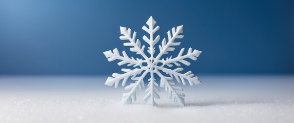 Elegant white snowflake on a vibrant blue background, perfect for winter themes and holidays