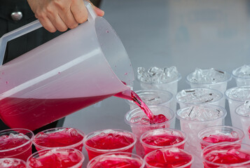 Red cold syrup in a plastic glass