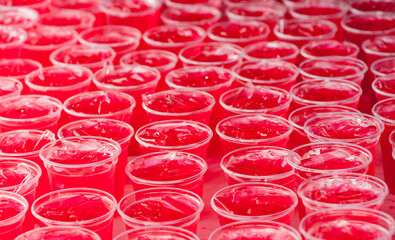 Red cold syrup in a plastic glass