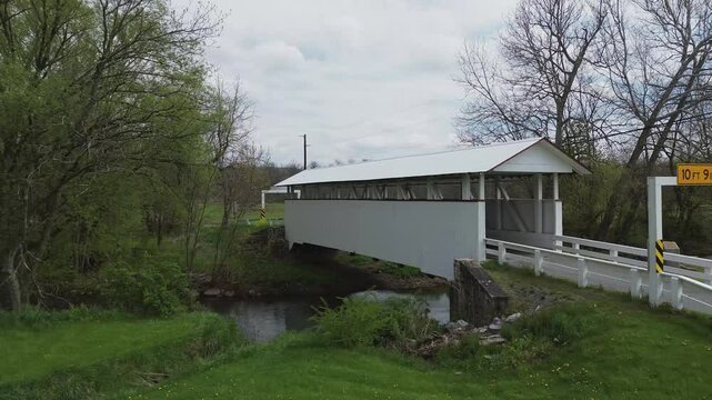 Snooks covered bridge near New Paris PA. Low level, rotating shot that highlights the open side and design of the bridge. Shot on an early Spring day.