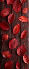 Autumn brown leaves scattered on dark wooden background, creating a natural and rustic aesthetic.