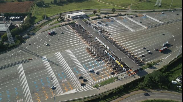 Aerial view of an Italian highway toll booth. Cars queuing up to pay the highway toll and automatic paying lanes.
