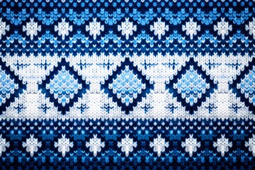 A detailed image of a knit pattern with traditional Fair Isle designs in blue and white