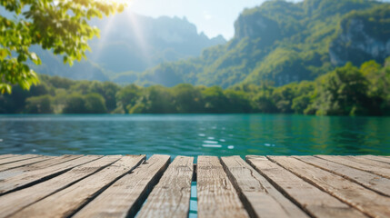 Sunlit wooden dock overlooking a serene lake surrounded by lush green mountains, perfect for nature lovers and outdoor enthusiasts.