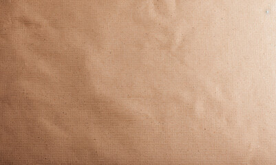 Naklejka premium Close-up of textured brown kraft paper surface, ideal for background or design elements. Neutral and natural material for various creative projects.