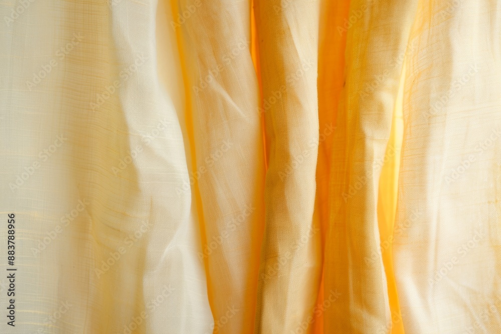 Poster abstract artistic display of mustard yellow fabric using long exposure technique in a soft beige and