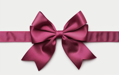 Elegant burgundy satin ribbon bow on a white background, perfect for gift wrapping, holiday decoration, or festive design projects.