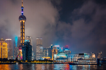 Obraz premium Urban skyscrapers in Shanghai at night; 