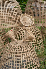 Traditional handmade woven bamboo chicken coops stacked outdoors these dome shaped traps or coops are used in rural southeast asia to house or capture poultry. © saksuvan