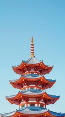 Stunning view of a traditional multi-tiered pagoda against a clear blue sky, showcasing intricate architectural details.
