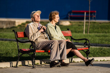 old couple sitting on a bench
