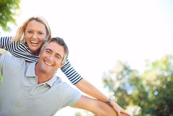Fototapeta premium Freedom, piggyback and portrait with couple in park together for anniversary, bonding or romance. Adventure, smile or travel with mature man and woman outdoor in nature for summer holiday or vacation
