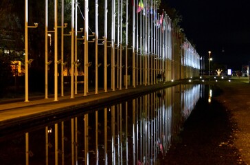 flagpoles and their reflection in the evening