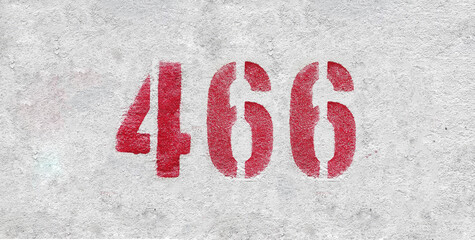 Red Number 466 on the white wall. Spray paint.