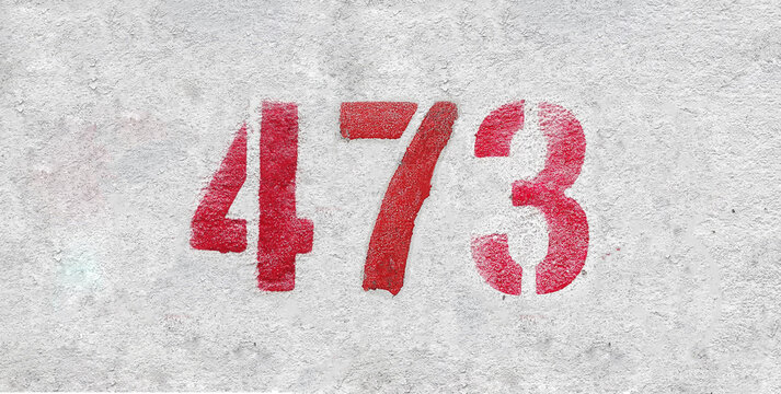 Red Number 473 on the white wall. Spray paint.