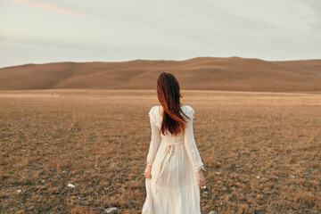 Tranquil sunset moment woman in white dress standing in open field beauty at dusk