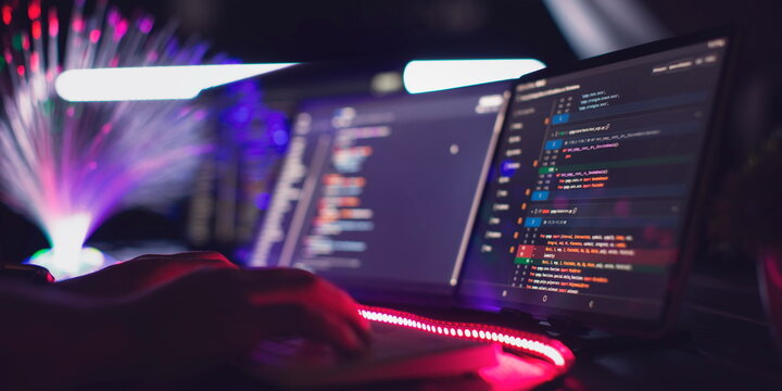 Program code on a computer monitor with fiber optic background. Internet and technology concept. Software application development