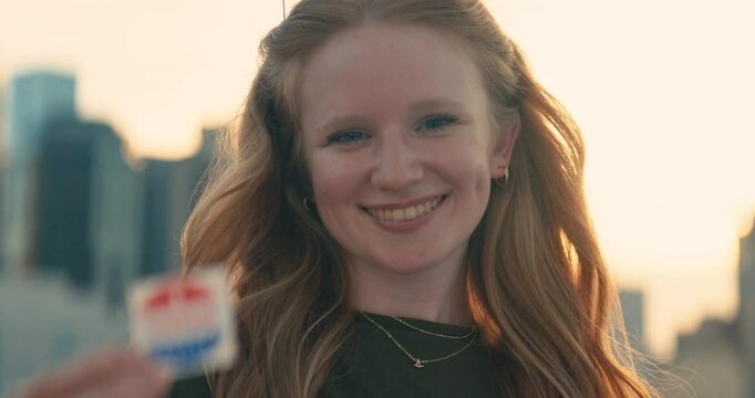 Young women smiling with an &lsquo;I Voted&rsquo; stickers and pin 