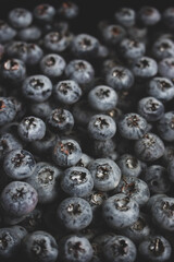Fresh blueberries in water close up top view. Black and blue juicy berries. Natural blue background. Summer vitamin harvest. Natural diet. Healthy food. Freshness concept. Group of ripe blueberries.
