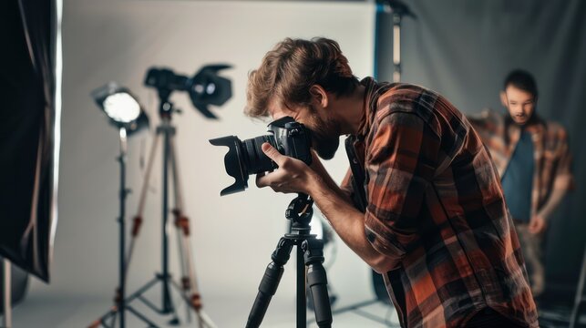 Photographer adjusting camera settings for a portrait in a studio.