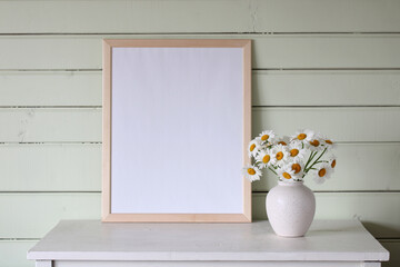 large empty frame, a mockup, a stage creator. a white table in the cottage, a light green wooden...