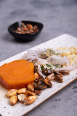 Traditional Peruvian dish called Ceviche with a portion of roasted corn, seen up close.