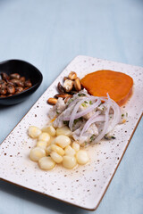 Traditional Peruvian dish called Ceviche presented with a portion of corn.