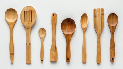 Assorted bamboo kitchen utensils against pure white, eco-friendly and modern