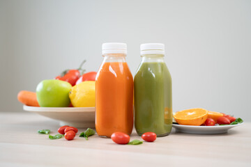 detox drink concept, bottle of vegetable and fruit mixed and variety fruit on the table.