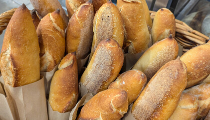 Close up of freshly baked crusty baguettes bread in a wicker basket