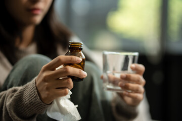 medicine, Sad and depressed young female sitting on the sofa, sad mood, feel tired, anxiety and unhappy concept.