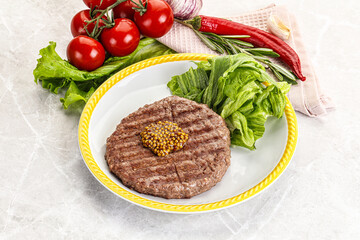 Frilled beef burger cutlet with iceberg