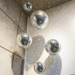 The background of the sparkling silver ball reflects the light