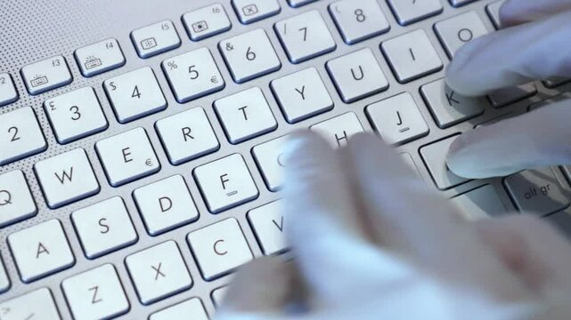 hands with white gloves typing, scientist using laptop
