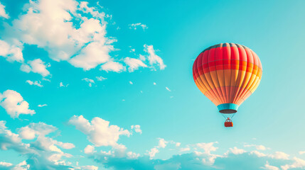 Fototapeta premium A hot air balloon floating in the sky with white clouds