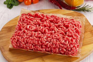Raw minced beef meat over board