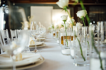 Elegant neutral coloured wedding table scape with flowers and candles