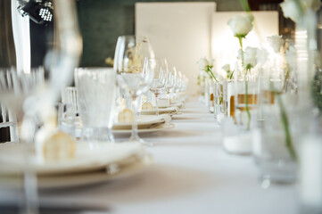 Elegant neutral coloured wedding table scape with flowers and candles