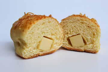 Cut bread with cheddar cheese cube inside, isolated on white background