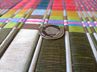 Coins on colored woven cloth