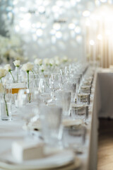 Elegant neutral coloured wedding table scape with flowers and candles