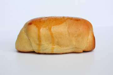One simple baked bread, isolated on white background