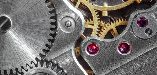 Ancient tiny metal clockwork close up background