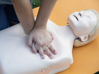 First aid training - mastering CPR techniques on a dummy