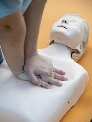 First aid training - mastering CPR techniques on a dummy