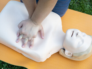 First aid training - mastering CPR techniques on a dummy
