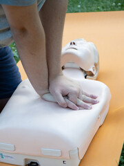 First aid training - mastering CPR techniques on a dummy